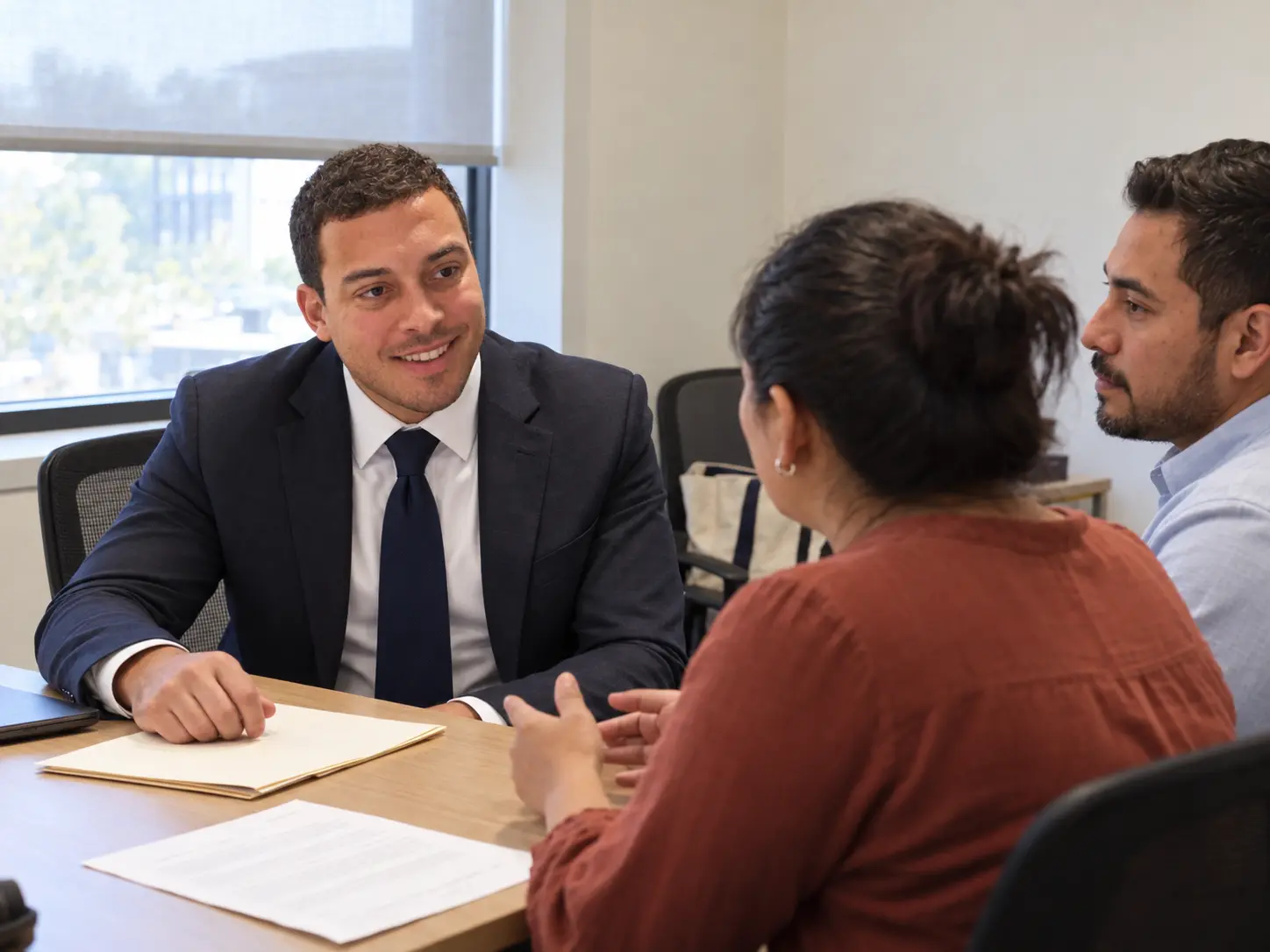 John Phillips speaking with a couple during an illustrative consultation.